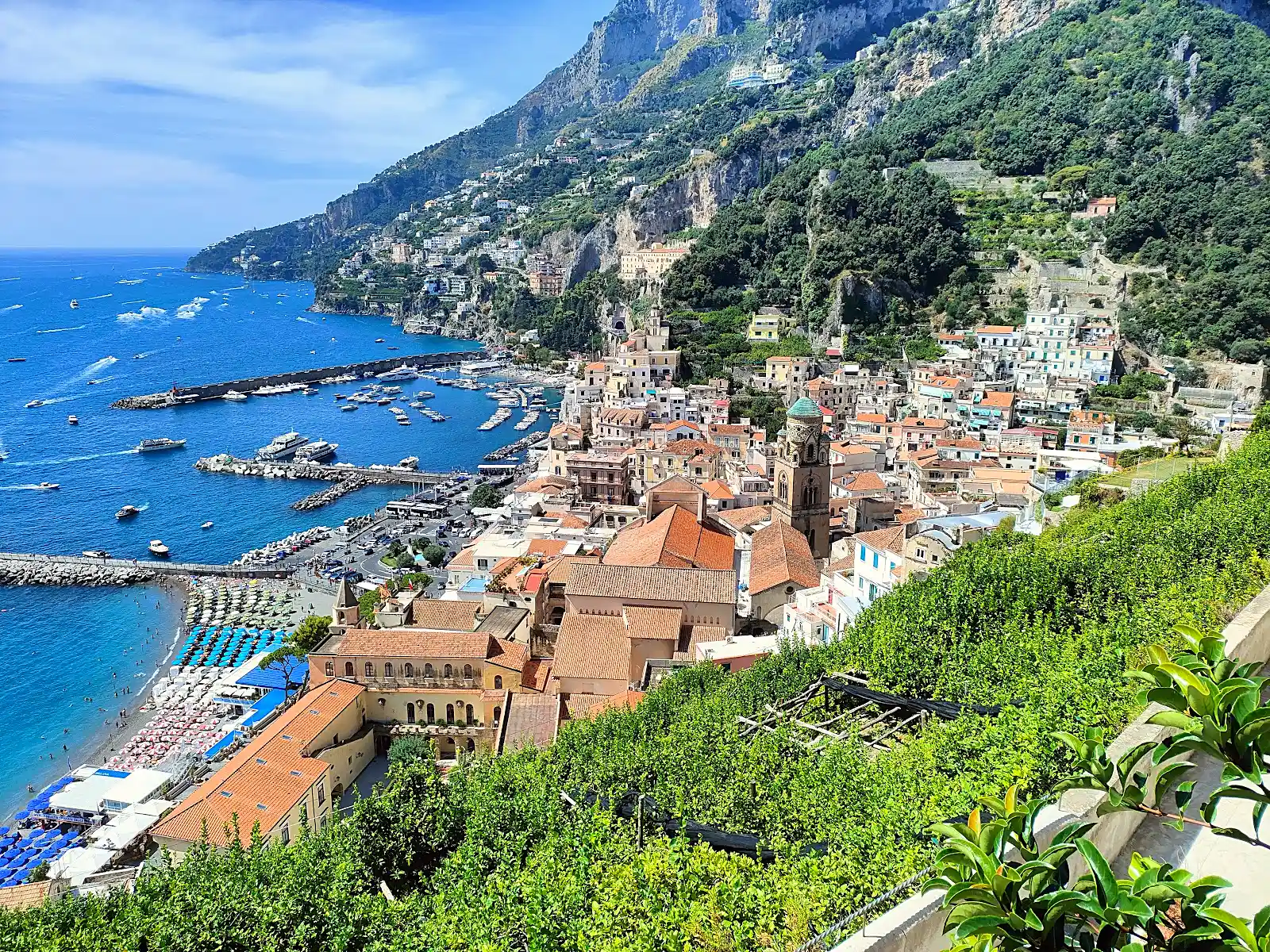traveller planning a travel itinerary with a map at a coastal destination in Italy