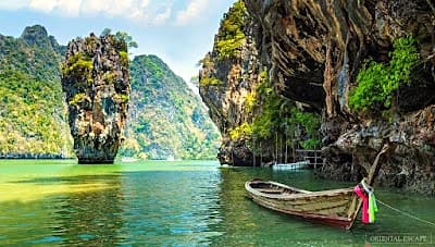 Phang Nga Bay limestone islands rising from calm green water near Phuket