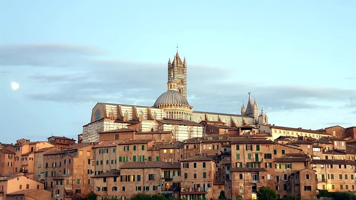 Hilltop view of Siena's medieval rooftops and tower in the Tuscan countryside