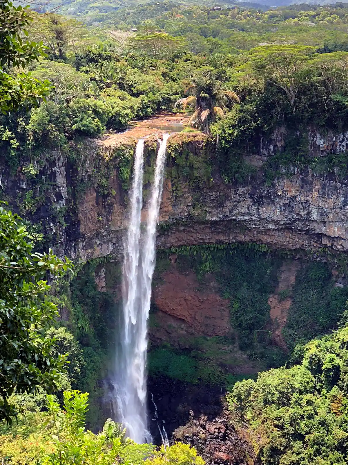 Chamarel waterfall dropping through green forest in Mauritius near the coloured earths
