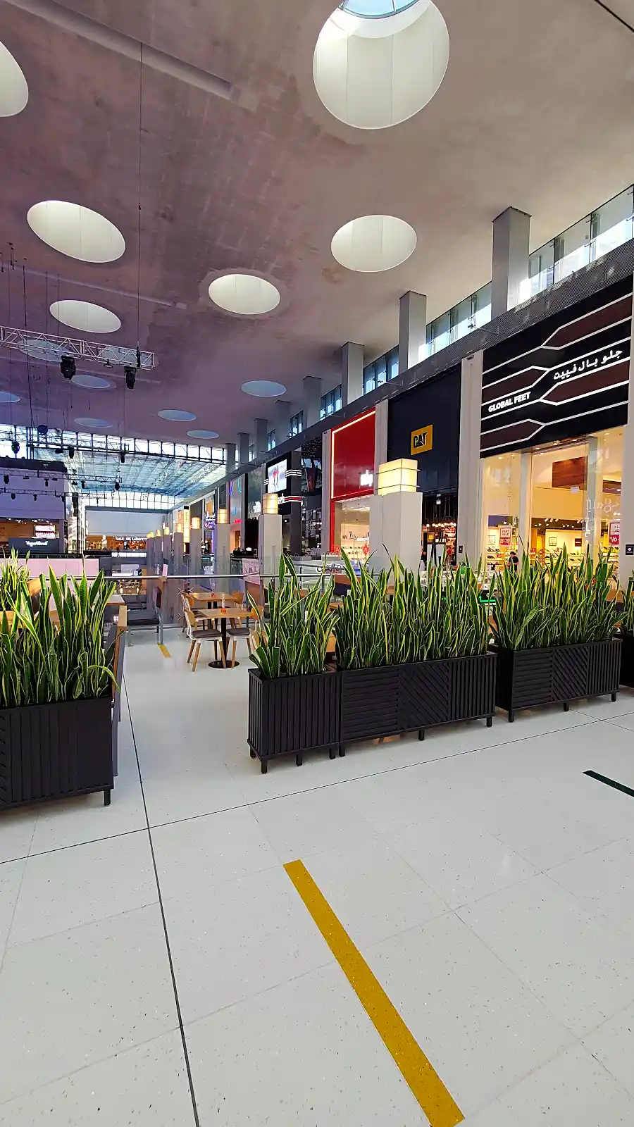 Interior of Dubai Mall with shoppers, part of Dubai's normal daily operations during the airspace advisory