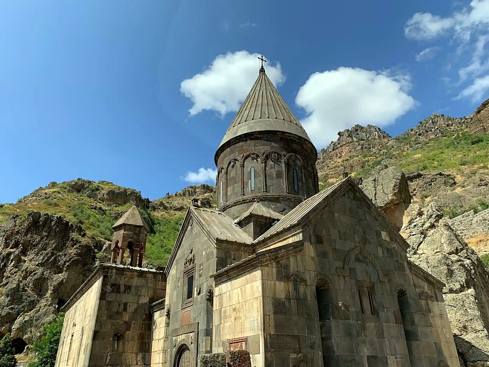 Geghard monastery carved into a rock cliff face in Armenia