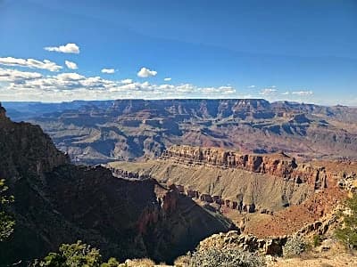 winding highway through red rock canyon on a classic usa road trip itinerary route