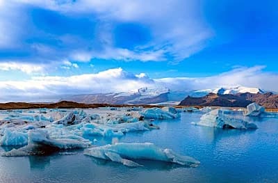 Icebergs drifting across Jokulsarlon glacier lagoon, the furthest stop on a South Coast iceland itinerary