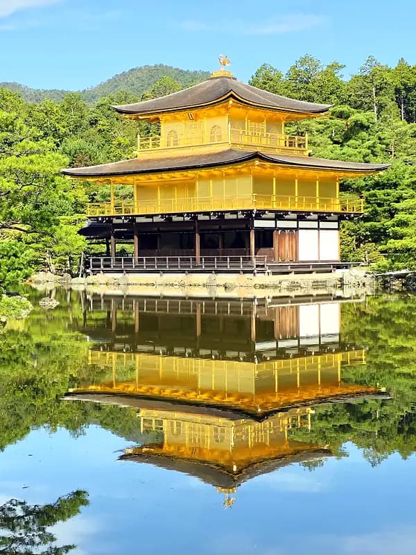 Kinkaku-ji golden pavilion reflected in still water in Kyoto Japan