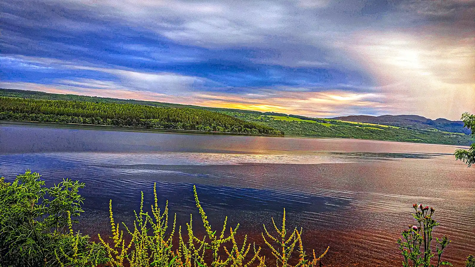 Loch Ness at dusk with Urquhart Castle ruins, the central stop on the Highland leg of a scotland itinerary