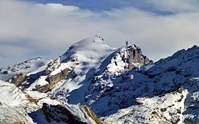 Snow-covered Mount Titlis peak above Swiss valley on a switzerland in winter itinerary