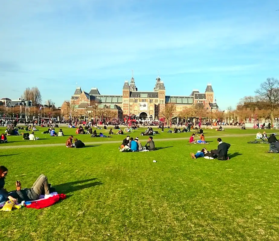 Open lawn and museum buildings around Museumplein square in Amsterdam