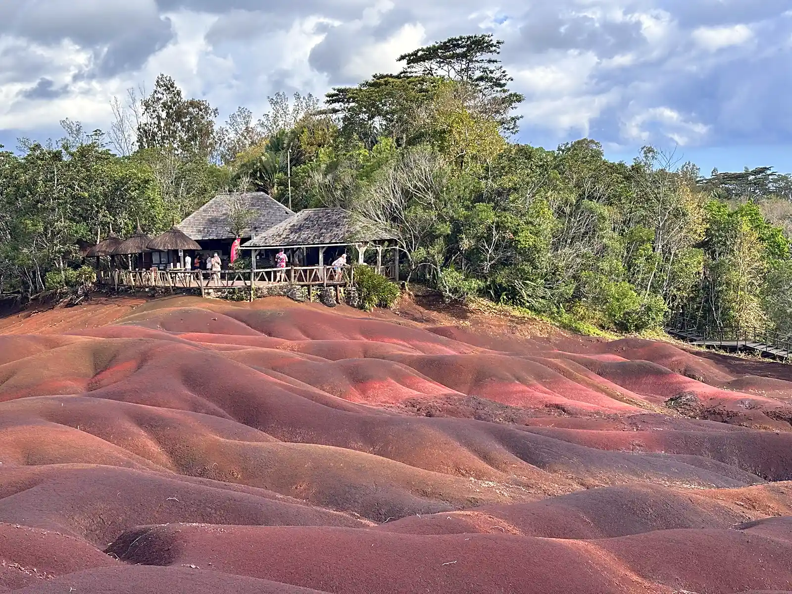 The Seven Coloured Earths geological formation in Chamarel, Mauritius, showing layers of volcanic soil in distinct hues