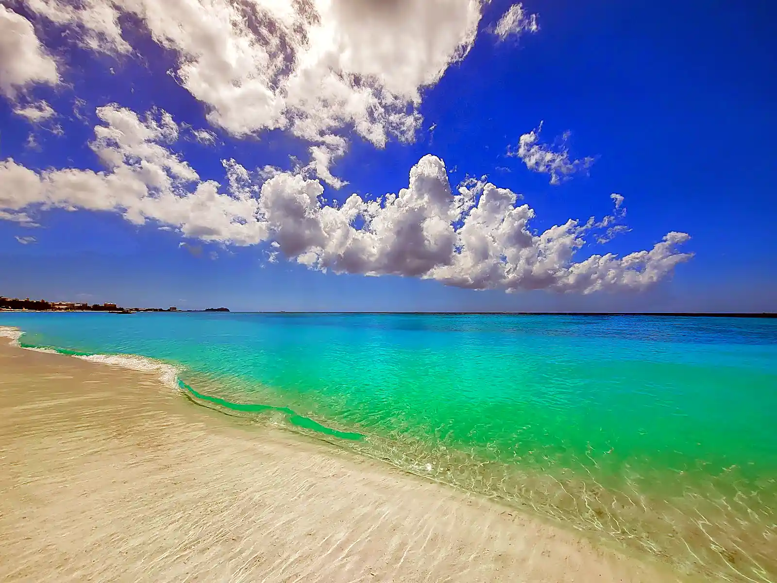 Seven Mile Beach lined with resorts, the default image behind most Caribbean trip plans
