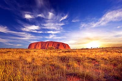 Uluru glowing red at sunset in the Australian outback